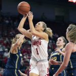 
              Nebraska's Jaz Shelley (1) shoots against Michigan's Izabel Varejão (34), from left, Danielle Rauch (23) and Leigha Brown (32) during the first half of an NCAA college basketball game Tuesday, Jan. 4, 2022, in Lincoln, Neb. (AP Photo/Rebecca S. Gratz)
            