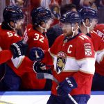 
              Florida Panthers center Aleksander Barkov (16) high-fives his teammates after scoring a goal against the Montreal Canadiens during the second period of an NHL hockey game, Saturday, Jan. 1, 2022, in Sunrise, Fla. (AP Photo/Michael Reaves)
            