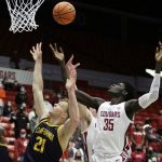 California forward Lars Thiemann (21) and Washington State forward Mouhamed Gueye (35) go after a rebound during the first half of an NCAA college basketball game, Saturday, Jan. 15, 2022, in Pullman, Wash. (AP Photo/Young Kwak)