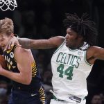 
              Indiana Pacers forward Domantas Sabonis, left, grabs a rebound against Boston Celtics center Robert Williams III (44) during the second half of an NBA basketball game, Monday, Jan. 10, 2022, in Boston. (AP Photo/Charles Krupa)
            