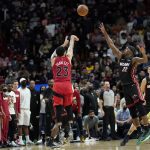 
              Toronto Raptors guard Fred VanVleet (23) shoots a three-point basket as Miami Heat forward Jimmy Butler (22) defends during overtime of an NBA basketball game, Saturday, Jan. 29, 2022, in Miami. (AP Photo/Lynne Sladky)
            