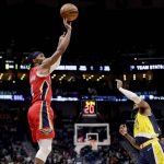 
              New Orleans Pelicans guard Devonte' Graham (4) shoots over Indiana Pacers forward Oshae Brissett (12) in the fourth quarter of an NBA basketball game in New Orleans, Monday, Jan. 24, 2022. (AP Photo/Derick Hingle)
            