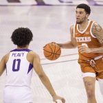
              Texas forward Timmy Allen, right, dribbles down the court against TCU guard Micah Peavy, left, in the first half of an NCAA college basketball game in Fort Worth, Texas, Tuesday, Jan. 25, 2022. (AP Photo/Gareth Patterson)
            