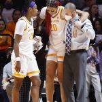 
              Tennessee center Tamari Key (20) is helped pff the court after being injured during an NCAA college basketball game against Kentucky, Sunday, Jan. 16, 2022, in Knoxville, Tenn. (AP Photo/Wade Payne)
            