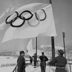 
              FILE - Members of Japan's self-defense ground forces raise Olympic flags in Sapporo, Japan, at Makomanai speed skating stadium in rehearsal of ceremony at official opening of Winter Olympic. on Jan. 23, 1972. (AP Photo, File)
            