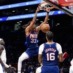 
              Brooklyn Nets forward Nic Claxton (33) dunks against the Los Angeles Clippers during the first half of an NBA basketball game Saturday, Jan. 1, 2022, in New York. (AP Photo/Jessie Alcheh)
            