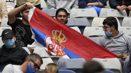 Serbian fans hold up their flag to support Laslo Djere of Serbia against Denis Shapovalov of Canada...