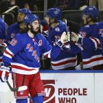 
              New York Rangers center Mika Zibanejad (93) is congratulated by teammates after scoring a goal against the Tampa Bay Lightning during the first period of an NHL hockey game, Sunday, Jan 2, 2022, at Madison Square Garden in New York. (AP Photo/Rich Schultz)
            