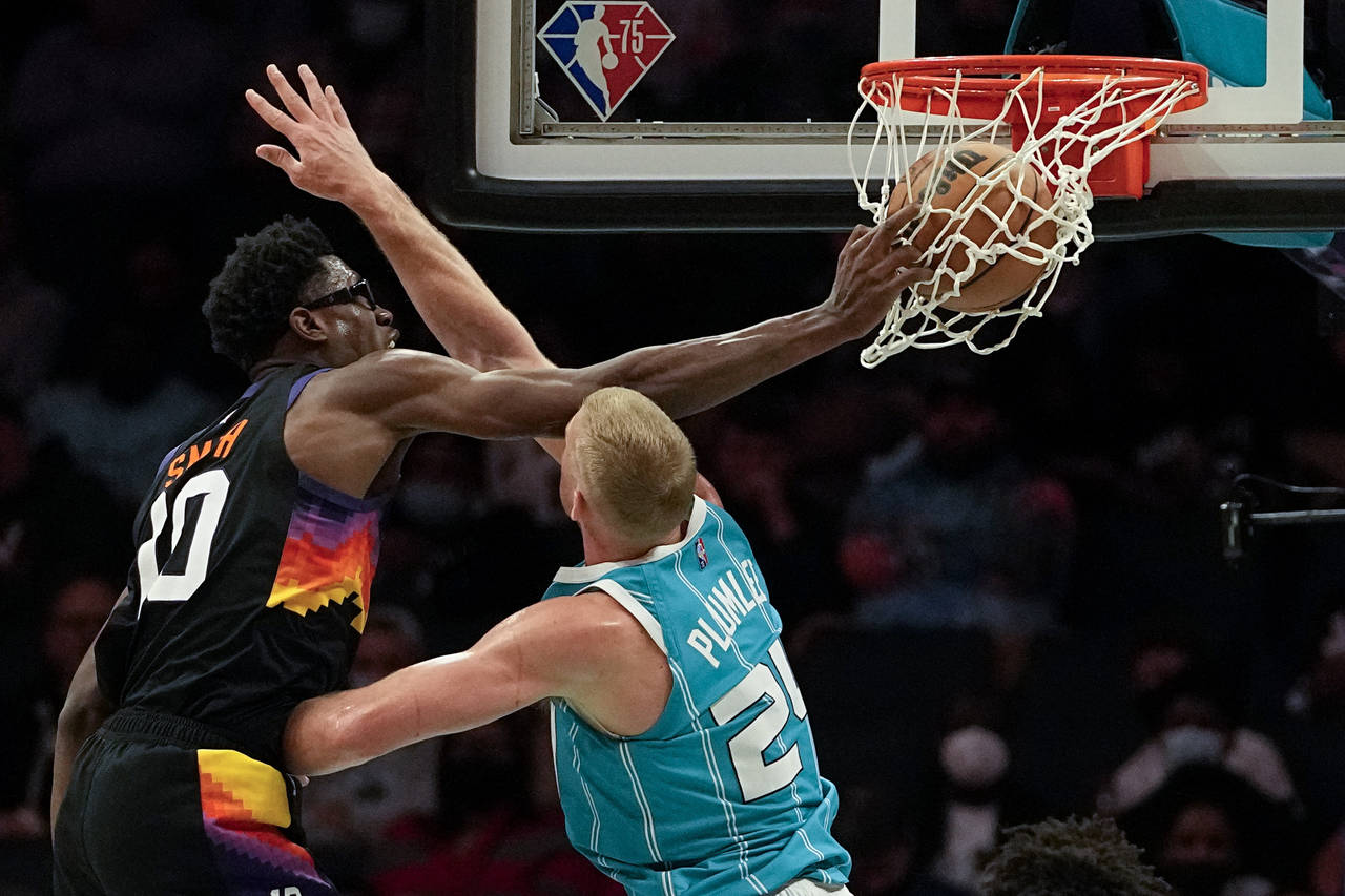 Phoenix Suns forward Jalen Smith dunks over Charlotte Hornets center Mason Plumlee during the secon...