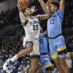 
              Villanova forward Jermaine Samuels (23) goes to the basket past Marquette forward Oso Ighodaro (13) during the first half of an NCAA college basketball game, Wednesday, Jan. 19, 2022, in Villanova, Pa. (AP Photo/Laurence Kesterson)
            