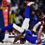 
              Buffalo Bills tight end Dawson Knox (88) scores a touchdown against New England Patriots safety Adrian Phillips (21) during the first half of an NFL wild-card playoff football game, Saturday, Jan. 15, 2022, in Orchard Park, N.Y. (AP Photo/Adrian Kraus)
            