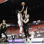 
              Washington State forward Efe Abogidi, left, shoots over Colorado forward Will Loughlin during the second half of an NCAA college basketball game, Sunday, Jan. 30, 2022, in Pullman, Wash. (AP Photo/Young Kwak)
            