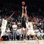 
              Florida State guard Wyatt Wilkes (31) shoots past Miami forward Anthony Walker (1) and guard Isaiah Wong (2) during the first half of an NCAA college basketball game, Saturday, Jan. 22, 2022, in Coral Gables, Fla. (AP Photo/Lynne Sladky)
            