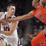 
              South Carolina guard Erik Stevenson, left, is defended by Auburn forward Jabari Smith, right, during the first half of an NCAA college basketball game Tuesday, Jan. 4, 2022, in Columbia, S.C. (AP Photo/Sean Rayford)
            