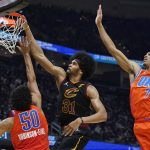 
              Cleveland Cavaliers' Jarrett Allen (31) dunks the ball against Oklahoma City Thunder's Jeremiah Robinson-Earl (50) Darius Bazley (7) and in the first half of an NBA basketball game, Saturday, Jan. 22, 2022, in Cleveland. (AP Photo/Tony Dejak)
            