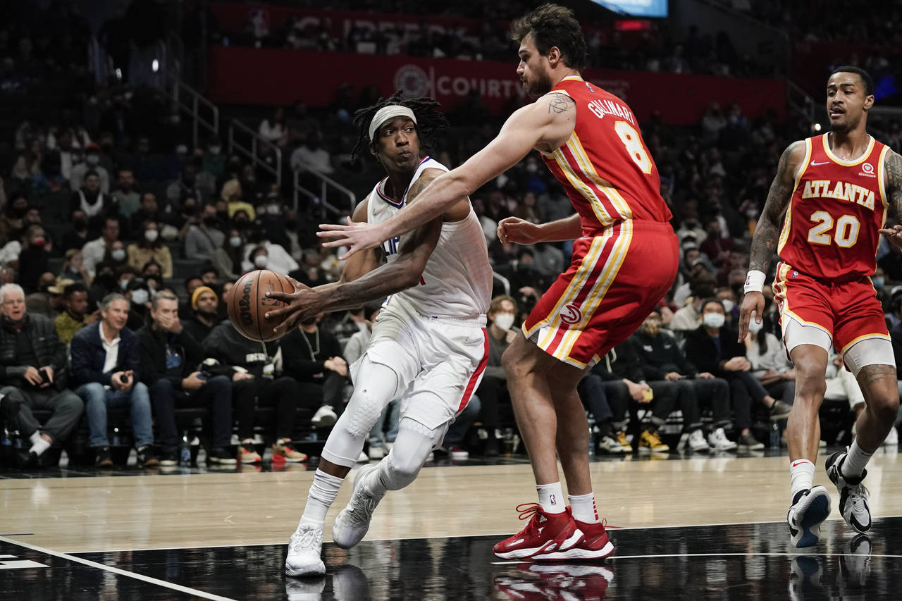 Los Angeles Clippers' Terance Mann, left, is defended by Atlanta Hawks' Danilo Gallinari during sec...