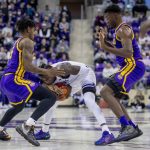 
              TCU's Damion Baugh, center, attempts to hold onto the ball as LSU's Mwani Wilkinson, left and Darius Days, right, defend in the first half of an NCAA college basketball game in Fort Worth, Texas, Saturday, Jan. 29, 2022. (AP Photo/Gareth Patterson)
            