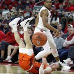 
              Virginia Tech's Storm Murphy (5) and North Carolina State's Casey Morsell (14) look at the loose ball after chasing after it during the first half of an NCAA college basketball game in Raleigh, N.C., Wednesday, Jan. 19, 2022. (Ethan Hyman/The News & Observer via AP)
            