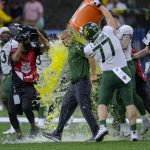 
              Baylor coach Dave Aranda is doused by offensive lineman Tate Williams (77) after the team's 21-7 victory over Mississippi in the Sugar Bowl NCAA college football game in New Orleans, Saturday, Jan. 1, 2022. (AP Photo/Matthew Hinton)
            