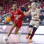 
              Louisville guard Kianna Smith (14) drives the ball up the court as Boston College guard Cameron Swartz (1) defends during the first half of an NCAA college basketball game, Sunday, Jan. 16, 2022, in Boston. (AP Photo/Mary Schwalm)
            