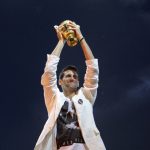 
              FILE - Novak Djokovic reacts as he lifts up the Wimbledon men's singles trophy in Belgrade, Serbia, July 4, 2011. The turning point of his career came in 2011, when Djokovic won 10 titles that included three Grand Slams and he achieved the No. 1 ranking in men’s tennis for the first time. (AP Photo/ Marko Drobnjakovic, File)
            