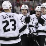 
              Los Angeles Kings right wing Carl Grundstrom (91) is congratulated by teammates after scoring a goal during the third period of an NHL hockey game against the New Jersey Devils, Sunday, Jan. 23, 2022, in Newark, N.J. (AP Photo/Adam Hunger)
            