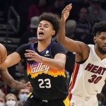 
              Phoenix Suns' Cameron Johnson (23) reacts after being hit on the head by Miami Heat's Chris Silva (30) during the second half of an NBA basketball game Saturday, Jan. 8, 2022, in Phoenix. (AP Photo/Darryl Webb)
            