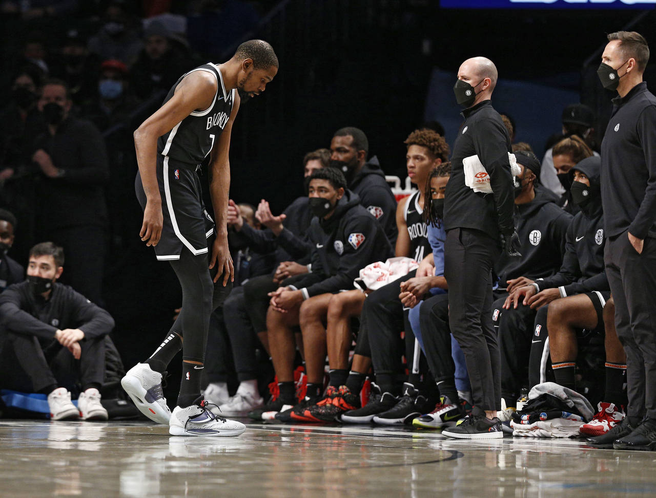 Brooklyn Nets forward Kevin Durant (7) leaves the game after injuring his knee during the first hal...