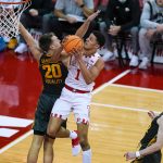
              Wisconsin's Johnny Davis (1) shoots against Iowa's Payton Sandfort (20) during the first half of an NCAA college basketball game Thursday, Jan. 6, 2022, in Madison, Wis. Wisconsin won 87-78. (AP Photo/Andy Manis)
            