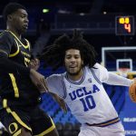 
              Oregon forward Eric Williams Jr. (50) defends against UCLA guard Tyger Campbell (10) during the first half of an NCAA college basketball game in Los Angeles, Thursday, Jan. 13, 2022. (AP Photo/Ashley Landis)
            