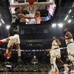 
              Milwaukee Bucks' Giannis Antetokounmpo is foukled by New York Knicks' Mitchell Robinson as he shoots during the first half of an NBA basketball game Friday, Jan. 28, 2022, in Milwaukee. (AP Photo/Morry Gash)
            
