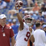 
              FILE - Alabama quarterback Bryce Young (9) warms up as offensive coordinator Bill O'Brien, left, watches before an NCAA college football game against Florida, on Sept. 18, 2021, in Gainesville, Fla. Young views the Heisman Trophy as about what he and Alabama have already done, not what the top-ranked Crimson Tide are still trying to accomplish in his first season as their starting quarterback. (AP Photo/Phelan M. Ebenhack, File)
            