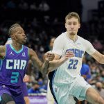 
              Orlando Magic forward Franz Wagner (22) drives in past Charlotte Hornets guard Terry Rozier (3) during the first half of an NBA basketball game on Friday, Jan. 14, 2022, in Charlotte, N.C. (AP Photo/Rusty Jones)
            