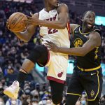 
              Miami Heat forward Jimmy Butler, left, looks to pass the ball while being defended by Golden State Warriors forward Draymond Green during the first half of an NBA basketball game in San Francisco, Monday, Jan. 3, 2022. (AP Photo/Jeff Chiu)
            