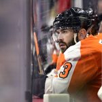 
              Philadelphia Flyers' Keith Yandle looks on from the bench during the first period of an NHL hockey game against the Dallas Stars, Monday, Jan. 24, 2022, in Philadelphia. Yandle tied the NHL record for consecutive games played with 964 on Monday. (AP Photo/Derik Hamilton)
            