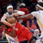 
              Houston Rockets forward Jae'Sean Tate (8) battles to keep the ball as Golden State Warriors guard Moses Moody, top left, and center Kevon Looney (5) reach in for a steal during the first half of an NBA basketball game Monday, Jan. 31, 2022, in Houston. (AP Photo/Michael Wyke)
            