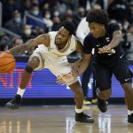 
              Providence guard Al Durham (1) controls the ball ahead of a steal attempt by Butler guard Chuck Harris (3) during the second half of an NCAA college basketball game, Sunday, Jan. 23, 2022, in Providence, R.I. (AP Photo/Mary Schwalm)
            