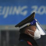 
              A Chinese paramilitary policeman wearing a face shield and mask to protect from the coronavirus stands guard at an entrance gate to a barricaded Main Press Center (MPC) for the Winter Olympic Games in Beijing, Wednesday, Jan. 19, 2022. China has locked down parts of Beijing's Haidian district following the detection of three cases, just weeks before the capital is to host the Winter Olympic Games. (AP Photo/Andy Wong)
            
