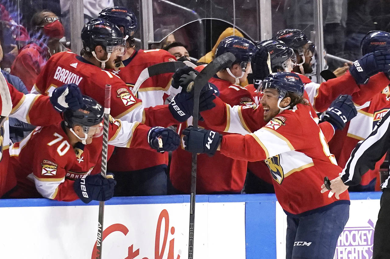 Florida Panthers left wing Ryan Lomberg, right, celebrates after scoring a goal during the second p...