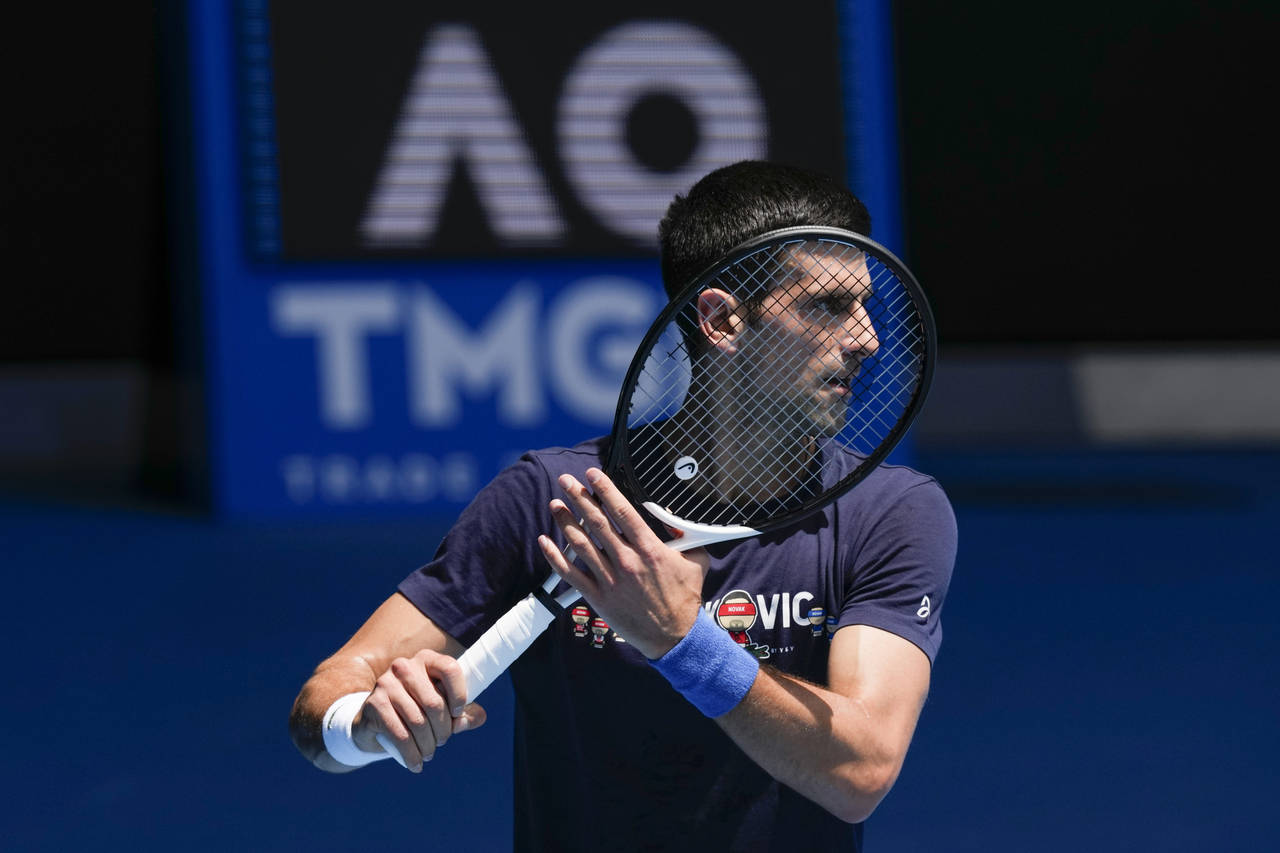 FILE - Defending men's champion Serbia's Novak Djokovic practices on Rod Laver Arena ahead of the A...