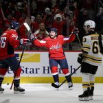 
              Washington Capitals left wing Conor Sheary, center, celebrates his goal with center Nic Dowd (26) during the first period of an NHL hockey game against the Boston Bruins, Monday, Jan. 10, 2022, in Washington. Bruins left wing Brad Marchand (63) looks on. (AP Photo/Nick Wass)
            