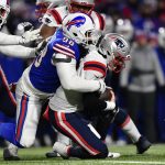 
              New England Patriots quarterback Mac Jones (10) is sacked by Buffalo Bills defensive tackle Star Lotulelei (98) during the first half of an NFL wild-card playoff football game, Saturday, Jan. 15, 2022, in Orchard Park, N.Y. (AP Photo/Adrian Kraus)
            