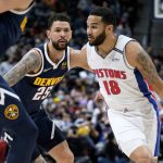 
              Detroit Pistons guard Cory Joseph, right, drives the lane past Denver Nuggets guard Austin Rivers in the first half of an NBA basketball game Sunday, Jan. 23, 2022, in Denver. (AP Photo/David Zalubowski)
            