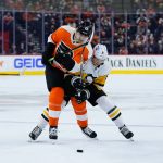 
              Philadelphia Flyers' James van Riemsdyk, left, and Pittsburgh Penguins' John Marino battle for the puck during the second period of an NHL hockey game, Thursday, Jan. 6, 2022, in Philadelphia. (AP Photo/Matt Slocum)
            