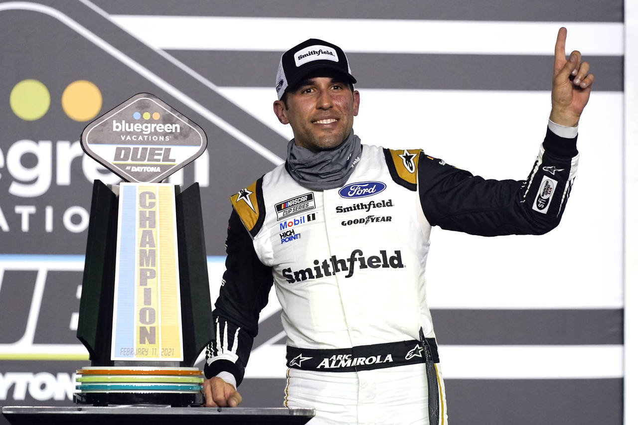FILE - Aric Almirola celebrates in Victory Lane after winning the first of two qualifying NASCAR au...