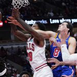 
              Golden State Warriors forward Nemanja Bjelica, center, battles for a rebound against Chicago Bulls forward Alfonzo McKinnie, left, and center Nikola Vucevic during the first half of an NBA basketball game in Chicago, Friday, Jan. 14, 2022. (AP Photo/Nam Y. Huh)
            