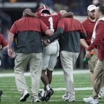 
              Alabama's Jameson Williams injures his knee after a catch during the first half of the College Football Playoff championship football game against Georgia Monday, Jan. 10, 2022, in Indianapolis. (AP Photo/Paul Sancya)
            