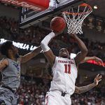 
              Texas Tech's Bryson Williams (11) shoots the ball around West Virginia's Taz Sherman (12) during the first half of an NCAA college basketball game on Saturday, Jan. 22, 2022, in Lubbock, Texas. (AP Photo/Brad Tollefson)
            