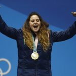 
              FILE - Women's snowboardcross gold medalist Michela Moioli, of Italy, celebrates during the medals ceremony at the 2018 Winter Olympics in Pyeongchang, South Korea, Friday, Feb. 16, 2018. Defending Olympic gold medalists Sofia Goggia and Michela Moioli both come from the Bergamo area that was the first epicenter of COVID-19 in Europe. Goggia skis with a design of Bergamo's skyline on the back of her racing helmet. Moioli lost her grandmother to the virus.  (AP Photo/Patrick Semansky, File)
            