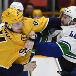 
              Nashville Predators left wing Tanner Jeannot (84) fights with Vancouver Canucks defenseman Kyle Burroughs (44) during the second period of an NHL hockey game Tuesday, Jan. 18, 2022, in Nashville, Tenn. (AP Photo/Mark Zaleski)
            